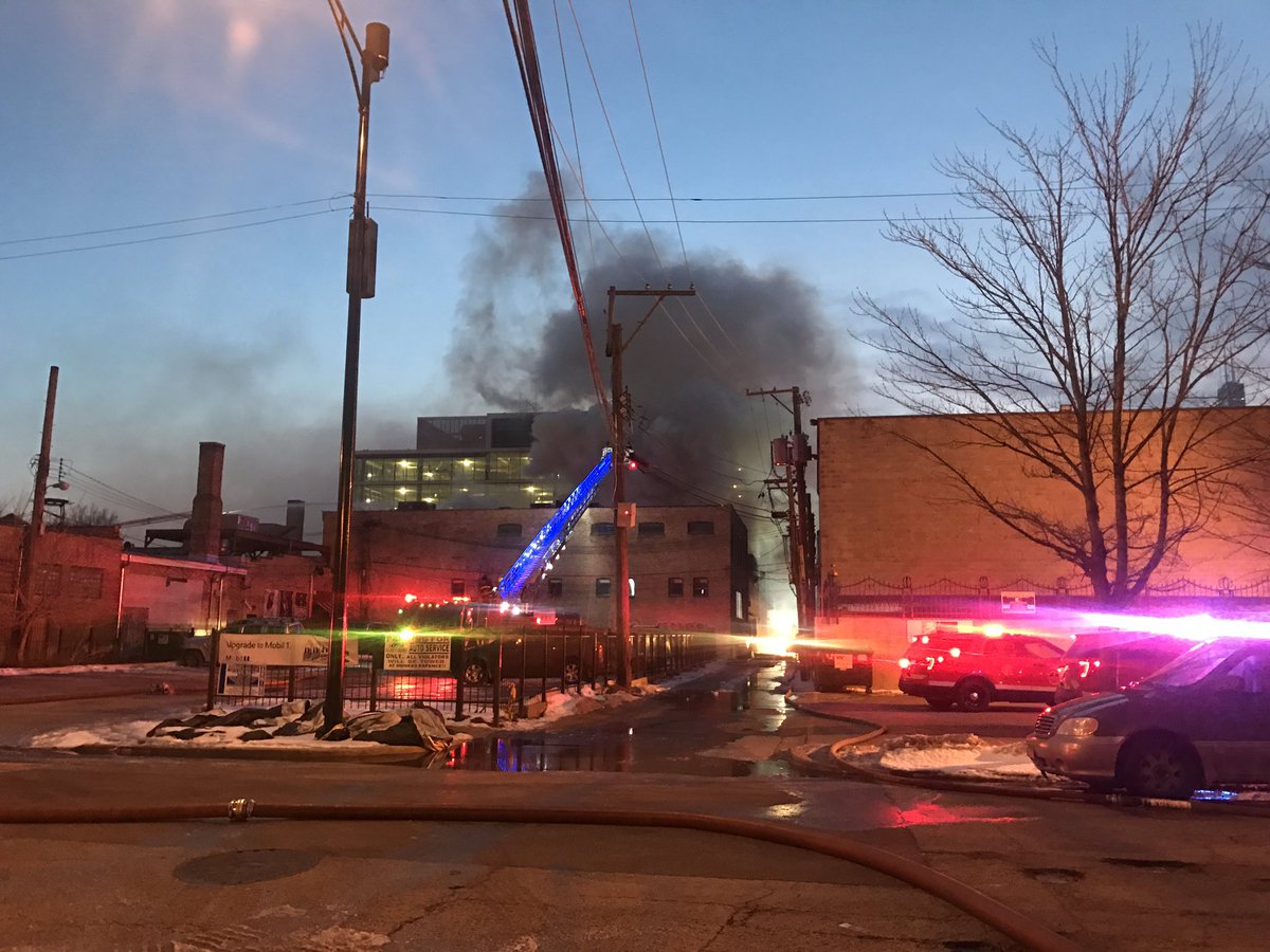 1200 block of West Lake St. Hazardous materials fire continues to burn through metal plating company. Fire isn't out. CTA trains stopped. No injuries. Green water pouring out of building. Not good