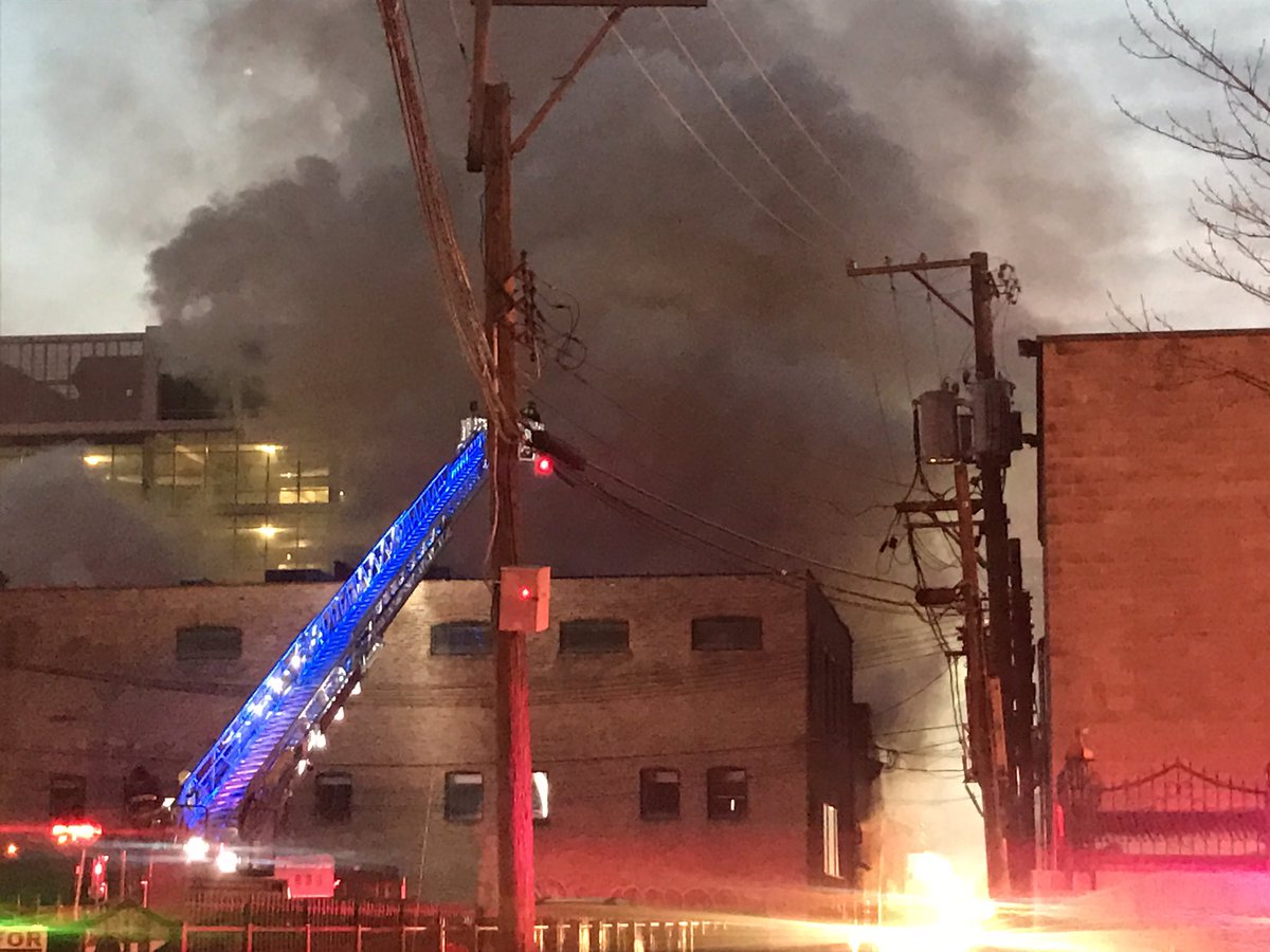 1200 block of West Lake St. Hazardous materials fire continues to burn through metal plating company. Fire isn't out. CTA trains stopped. No injuries. Green water pouring out of building. Not good