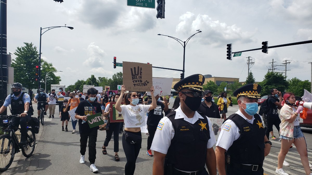 Area 4 Deputy Chief Ernest Cato and @ChicagoCAPS10 Commander Gilberto Calderon led CPD's public safety efforts for the peaceful march through LittleVillage this morning. As the sign says, We Are In This Together. CPDMediaCar