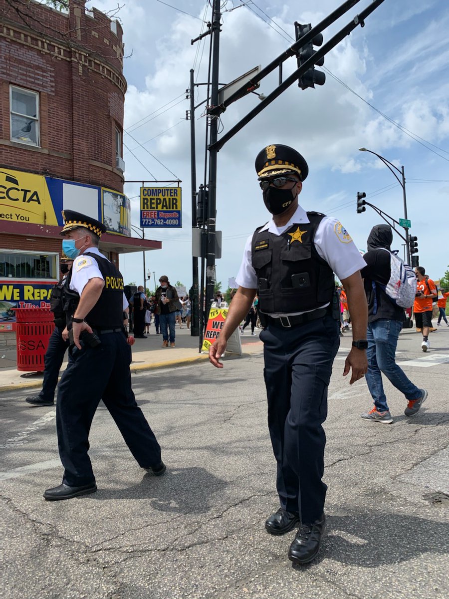 Area 4 Deputy Chief Ernest Cato and @ChicagoCAPS10 Commander Gilberto Calderon led CPD's public safety efforts for the peaceful march through LittleVillage this morning. As the sign says, We Are In This Together. CPDMediaCar