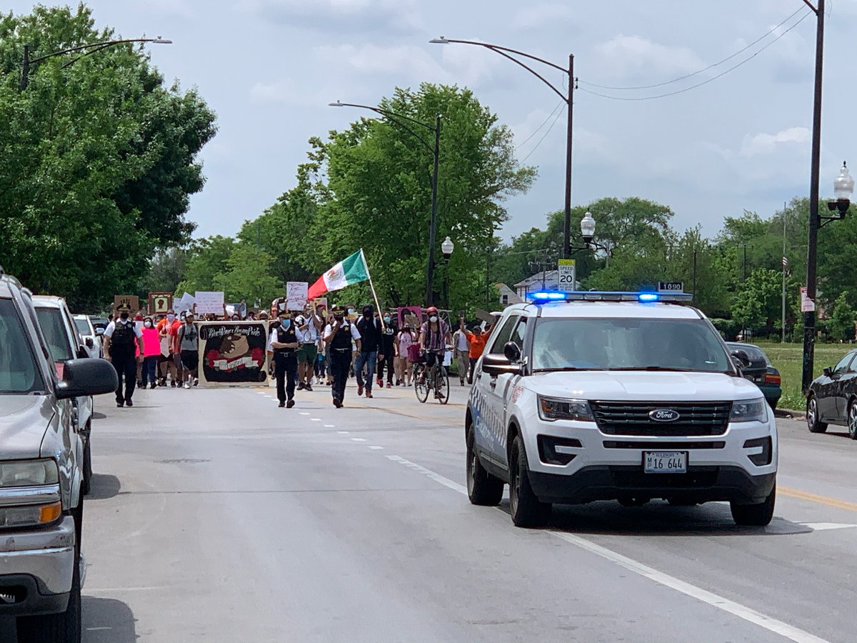 Area 4 Deputy Chief Ernest Cato and @ChicagoCAPS10 Commander Gilberto Calderon led CPD's public safety efforts for the peaceful march through LittleVillage this morning. As the sign says, We Are In This Together. CPDMediaCar