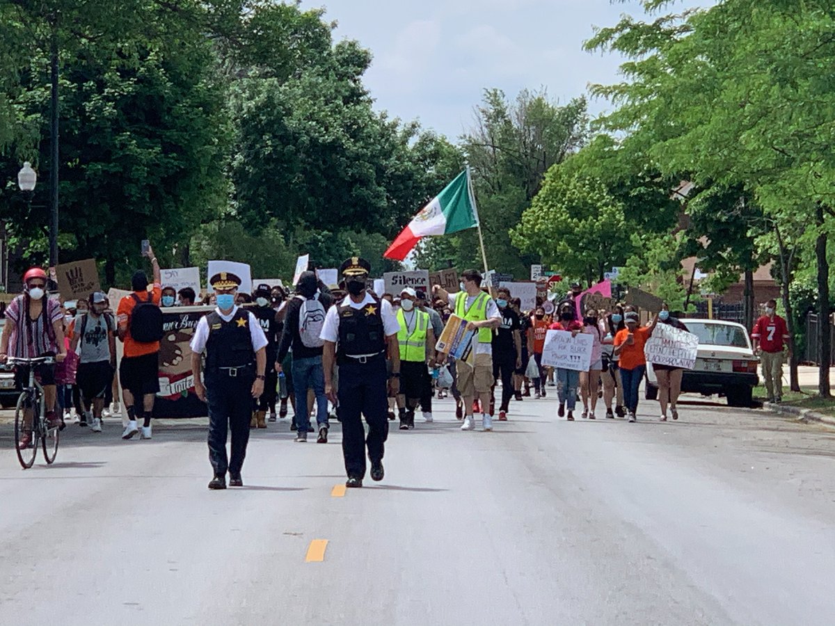 Area 4 Deputy Chief Ernest Cato and @ChicagoCAPS10 Commander Gilberto Calderon led CPD's public safety efforts for the peaceful march through LittleVillage this morning. As the sign says, We Are In This Together. CPDMediaCar