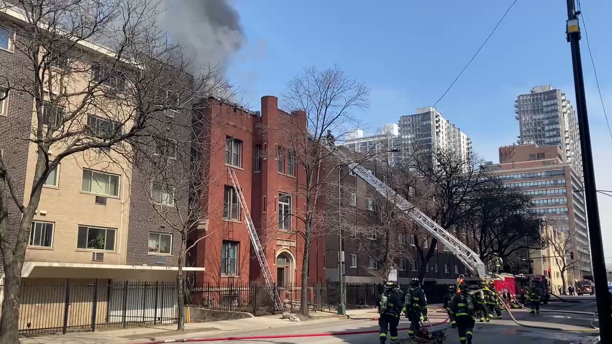 Firefighters now on the roof with hoses, battling flames