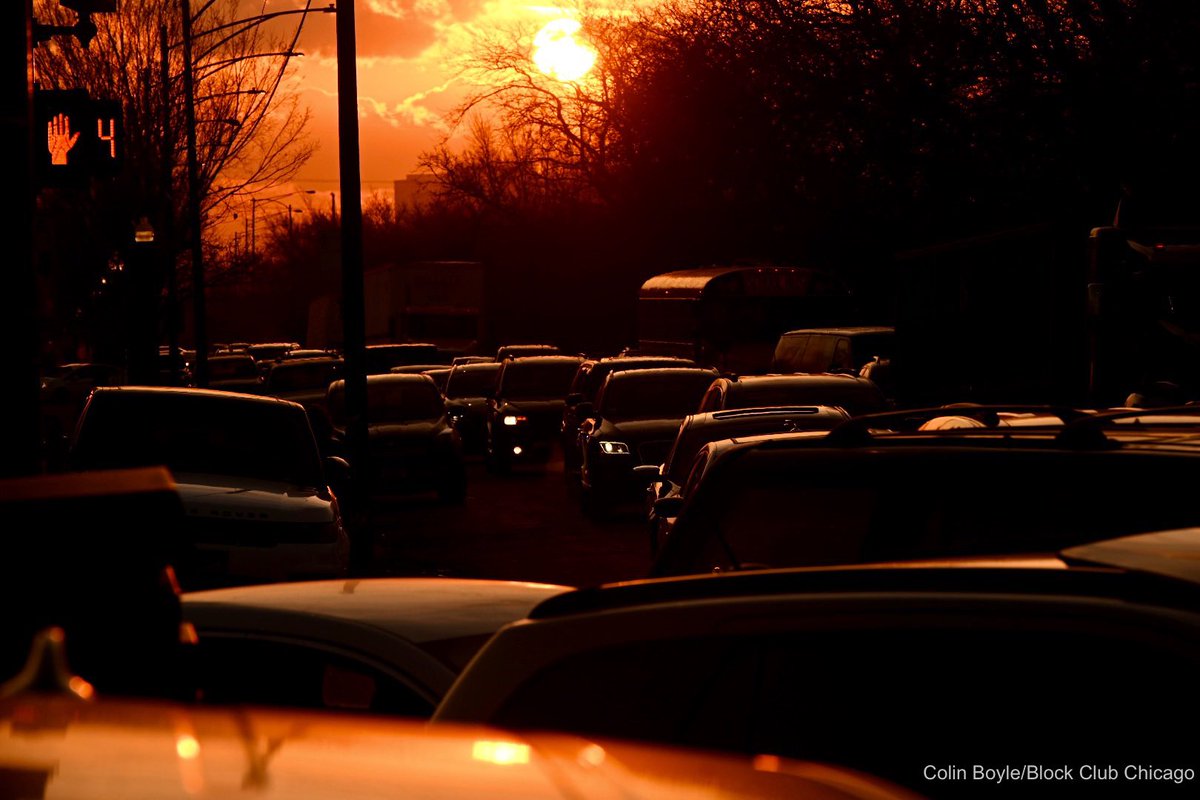 Here is the sun rising over the traffic that is snarled for BLOCKS in every direction as people wait for free gas from Dr. Willie Wilson in Garfield Park.   