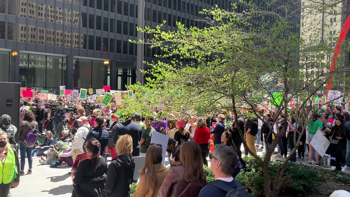 As the crowd defending abortion access grows outside the Dirksen federal courthouse, another, smaller group across the street hoists signs about prayer and Jesus.   Be a man and stand up for the rights of the unborn a man says into a microphone