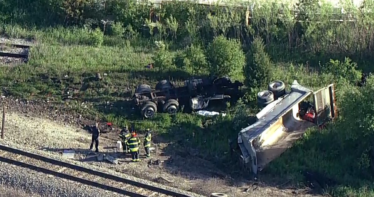 Grayslake - Metra MD N train hit dump truck near 120/HainsevilleRd.   Front car of train has derailed.We saw one passenger carried off on a stretcher.   MDN trains stopped both directions. No crossing gates at this crossing