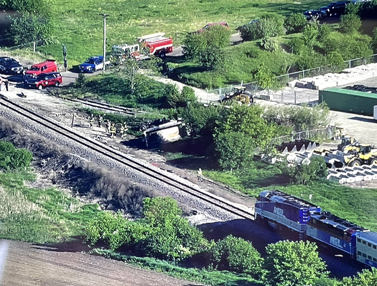 Milwaukee North Line train 2116 sits partly derailed after striking a 5 axle dump truck at a private crossing just south of Route 120 in Grayslake. No word yet on injuries to the truck driver or anyone aboard the train. s at