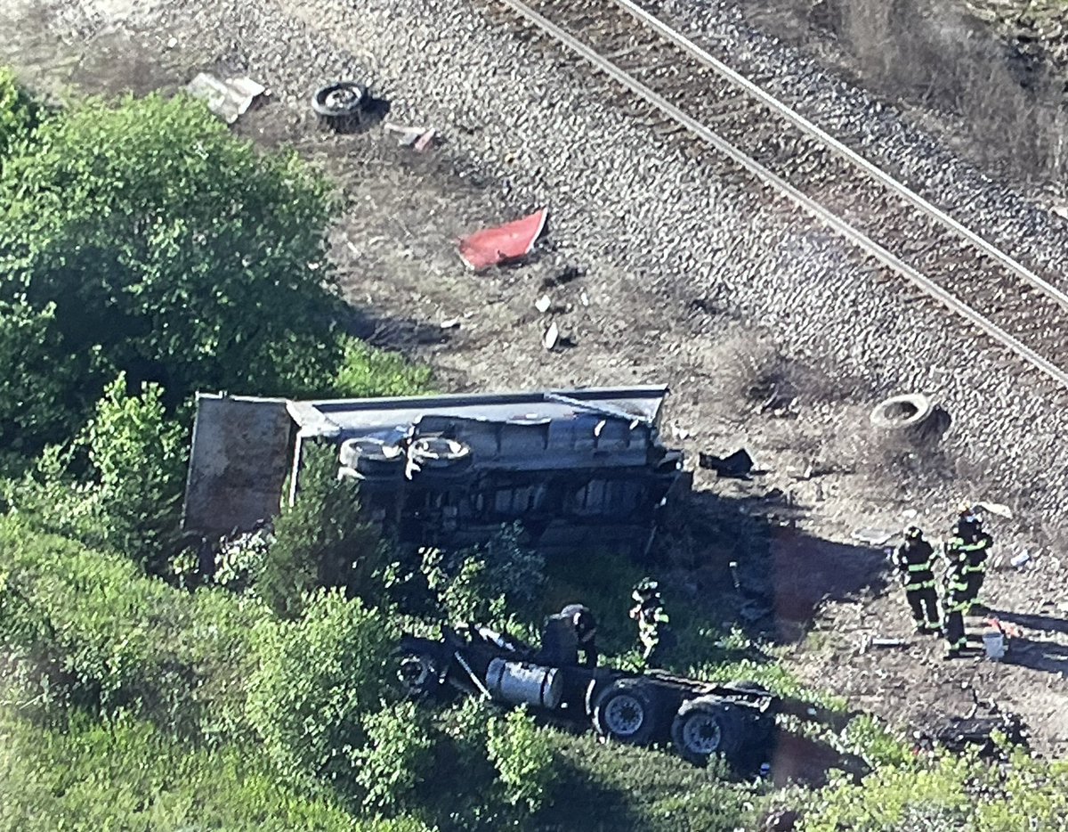 A 5 axle dump truck lies alongside the tracks after being hit by IB METRA Milwaukee District North Line train 2116 in Grayslake. No word on the driver, however, the truck was obliterated and the cab car of the train derailed. 