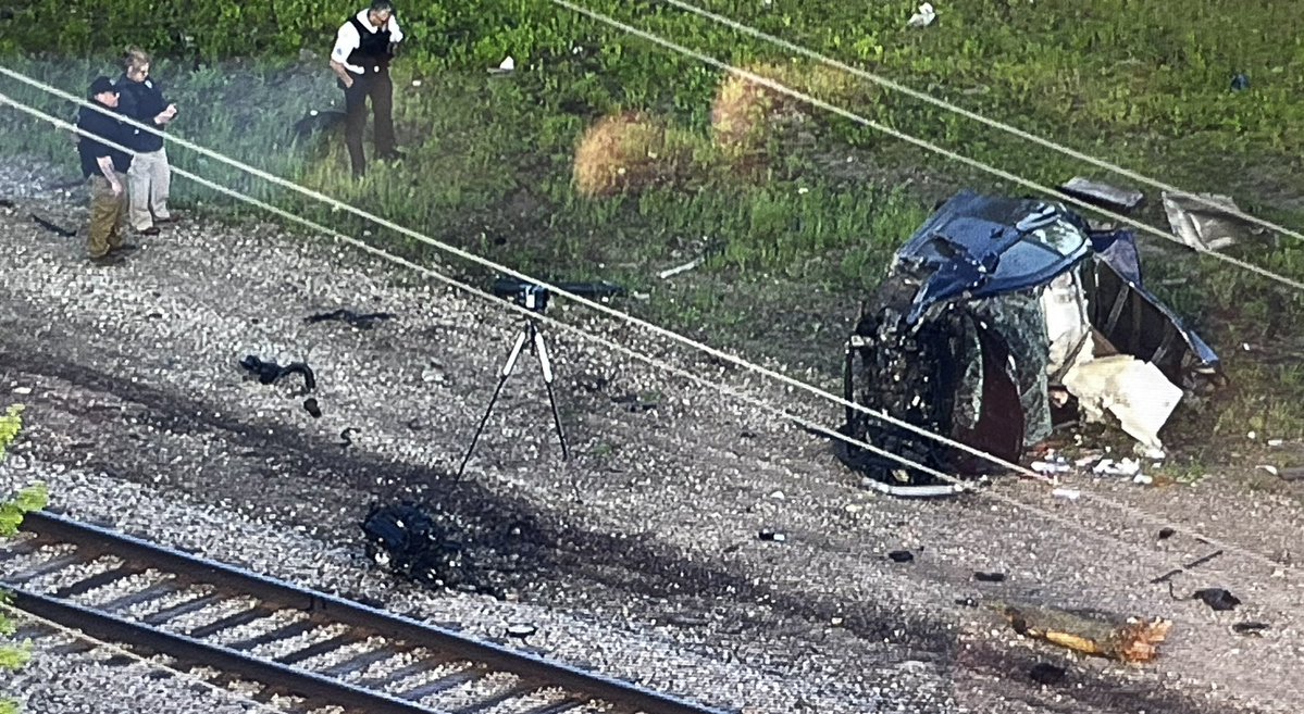 Chicago Police Major Accident Unit investigators look over a crash in Gresham that left a 29 year old woman dead and destroyed her car The violent  crash near 93rd & Vincennes tore the engine loose. Vincennes is closed north of 95th at the scene.