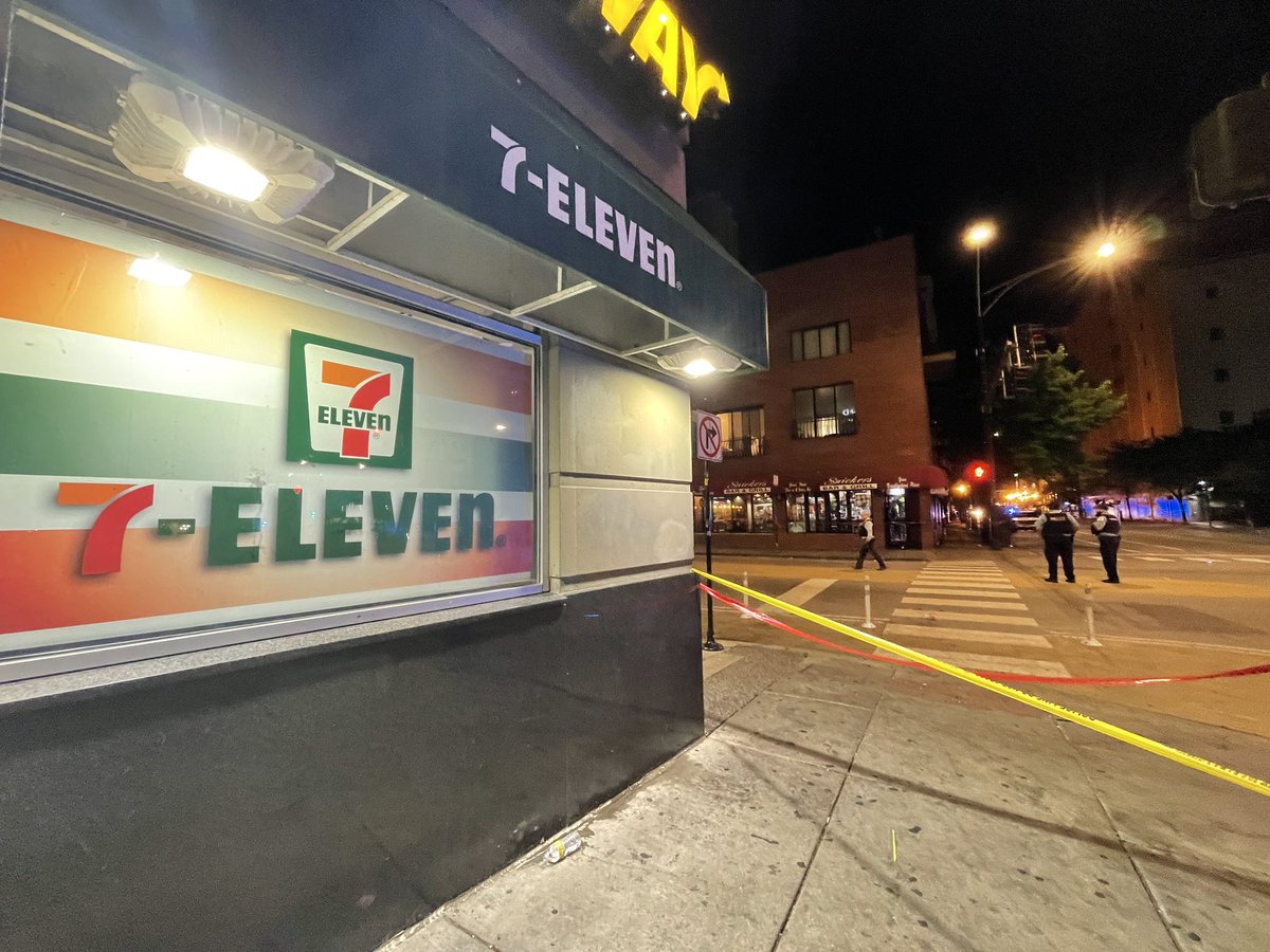 7/11 on State and Illinois outside a crime scene while the outdoor speakers of the 7/11 is playing opera music