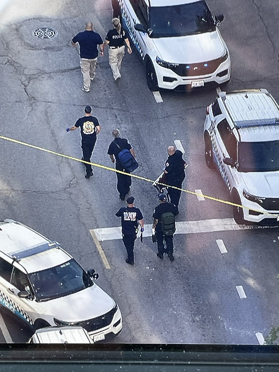 Yellow evidence markers surround an unmarked police car at 18th & Morgan in Pilsen after shots were reportedly fired  by police. 18th will remain closed as the scene is processed