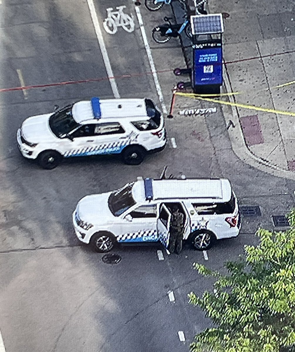 Yellow evidence markers surround an unmarked police car at 18th & Morgan in Pilsen after shots were reportedly fired  by police. 18th will remain closed as the scene is processed 