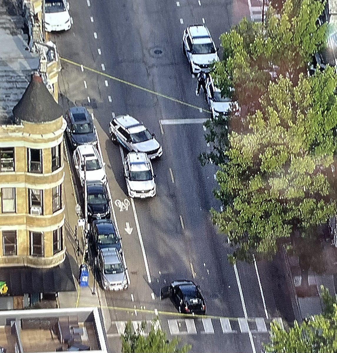 Yellow evidence markers surround an unmarked police car at 18th & Morgan in Pilsen after shots were reportedly fired  by police. 18th will remain closed as the scene is processed 