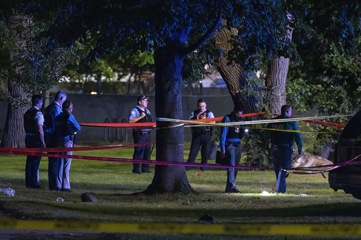 Chicago police work the scene where multiple people (possible as many as 13) were shot near a baseball field in Washington Park, Tuesday, Sept. 13, 2022.  