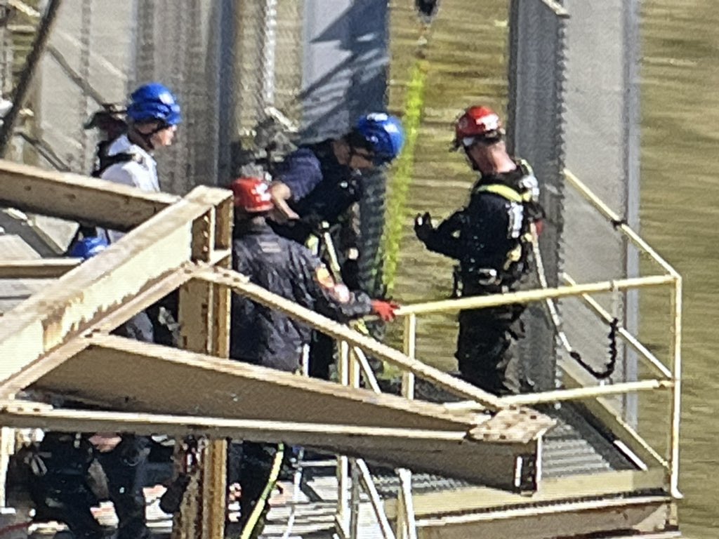 Chicago Fire Department Squad Co. members on scene at the south end of Calumet Harbor off 130th. 2 men have become stuck in an external elevator, 150' up a 200' dry cement storage silo. The 2 are fine and the CFD is here to make sure they stay ok. More at