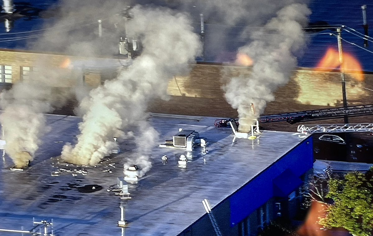 Smoke pushes out of open roof scuttles and one vent hole cut by the FD, during a blaze at the Tasty Bread factory on Fullerton at 25th Avenue in Franklin Park. No word of any injuries at this time. All FD companies are working