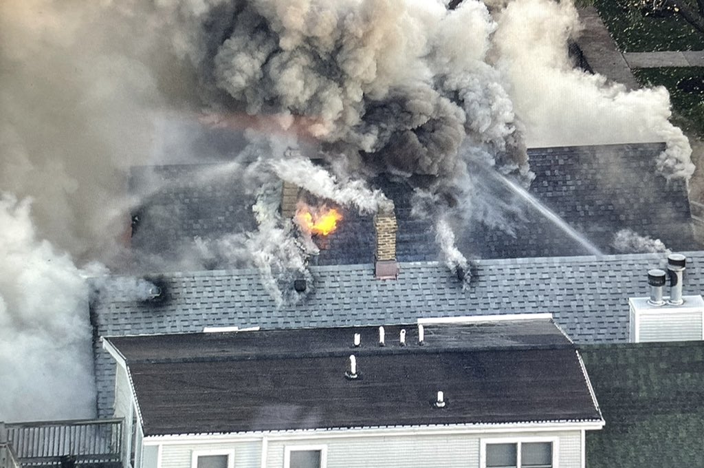 Chicago firefighters gaining point of vantage using fire damaged exposure buildings to get water into the seat of heavy fire in the 2400 block of N. Washtenaw. Operations are fully defensive, as the original fire building burns.