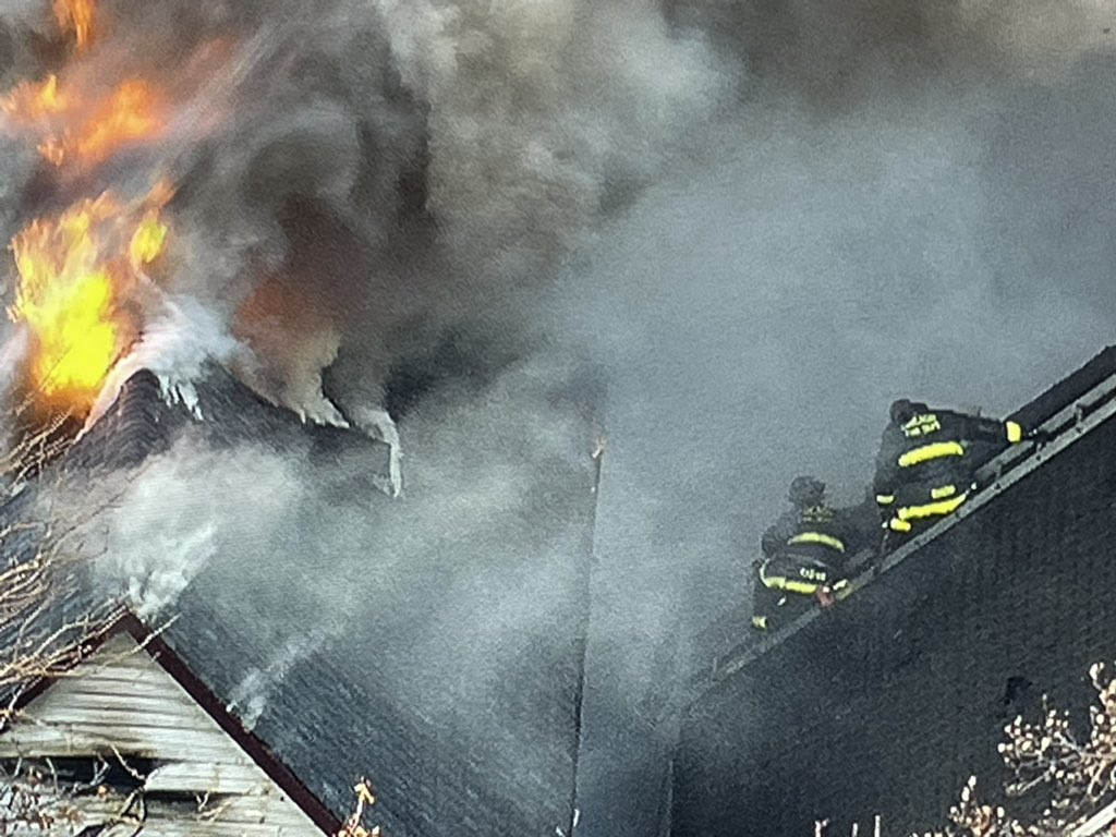 Chicago firefighters gaining point of vantage using fire damaged exposure buildings to get water into the seat of heavy fire in the 2400 block of N. Washtenaw. Operations are fully defensive, as the original fire building burns.  