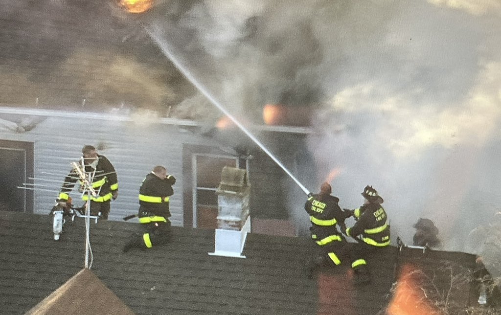 Chicago firefighters gaining point of vantage using fire damaged exposure buildings to get water into the seat of heavy fire in the 2400 block of N. Washtenaw. Operations are fully defensive, as the original fire building burns.  