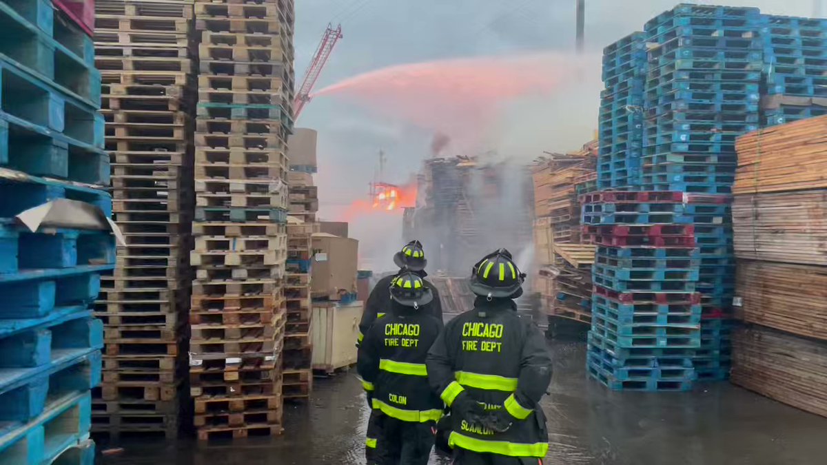 A 2 11 alarm a fire in a pallet yard 25 and Rockwell. Large number of pallets on fire.  No injuries report.  Wind making this more difficult